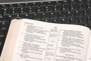 A Bible next to a keyboard