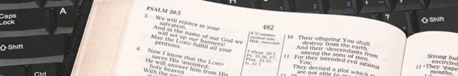A Bible next to a keyboard