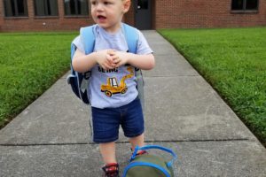 My son with his backpack and lunchbox outside of school