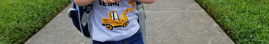 My son with his backpack and lunchbox outside of school