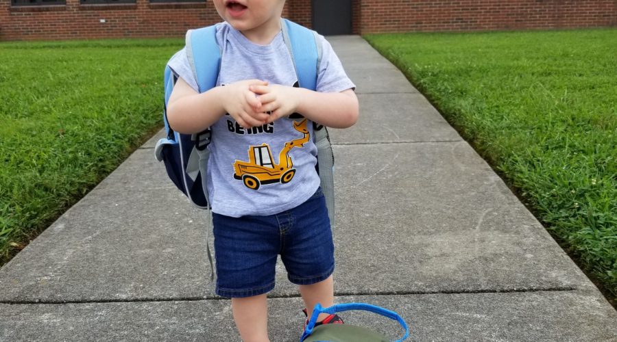 My son with his backpack and lunchbox outside of school
