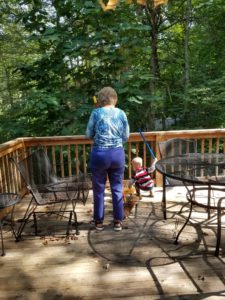 My son sweeping with his Great-Grandmother
