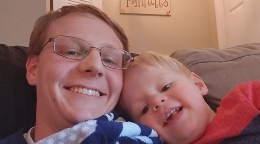 My son and I sitting on the couch together taking smiling