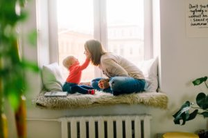 A picture of a mom parenting her child in a alcove at their home