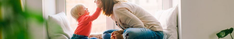 A picture of a mom parenting her child in a alcove at their home