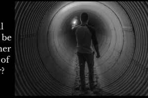 A man looking in fear down a human sized pipe with a flare to light his way.
