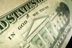 Picture of a 20 dollar bill with the words "In God we Trust" highlighted